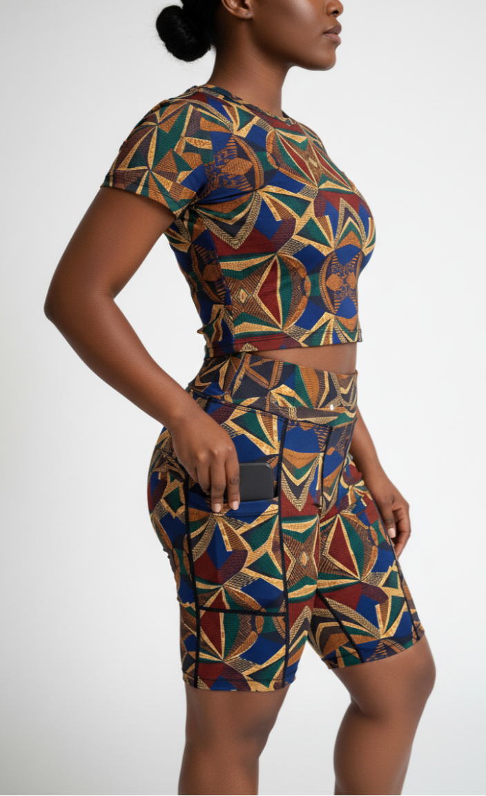 Woman wearing a colorful geometric patterned ankara active wear on a white background
