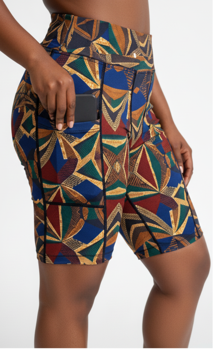 Colorful patterned ankara shorts worn by a person on a white background